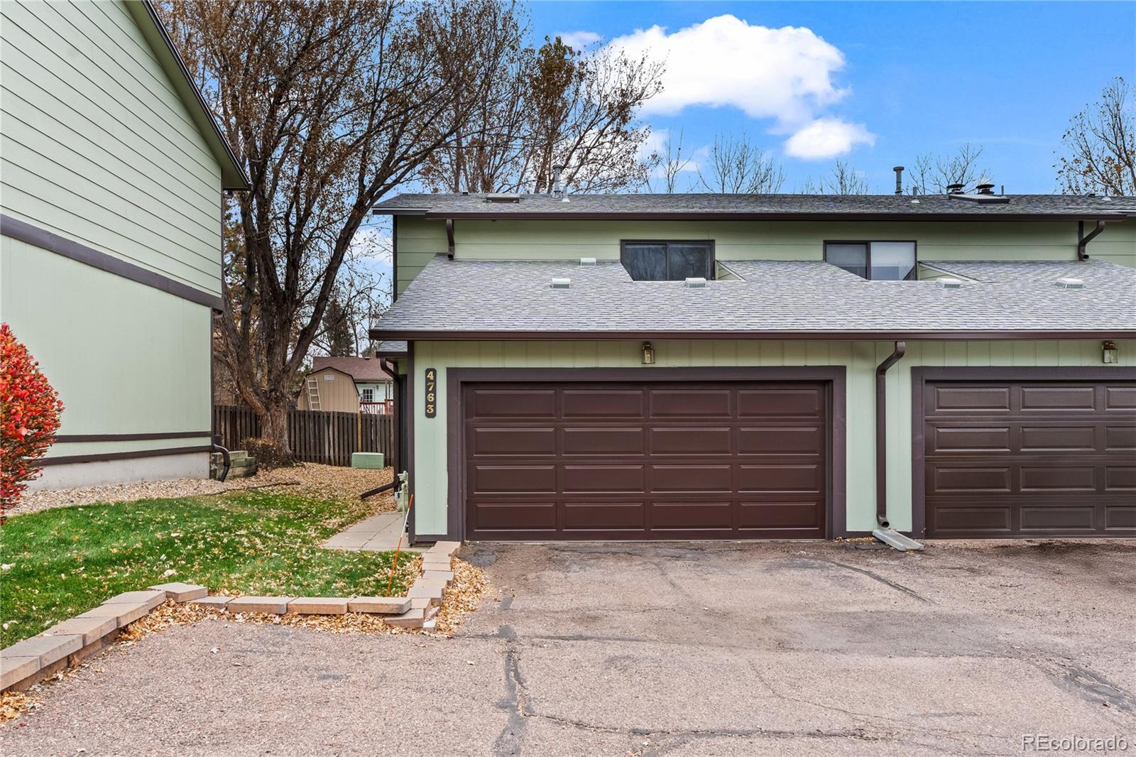 4763 Barnes Road Colorado Springs, CO 80917 - Photo 20 of 21 a front view of a house with a yard and garage