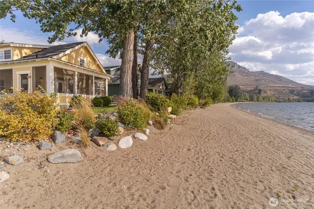 a front view of a house with a yard and trees