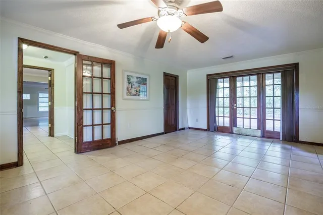 a view of an empty room with a fireplace and a window