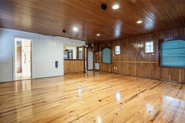 a view of an empty room with window and cabinet