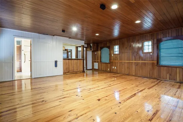 a view of an empty room with window and cabinet