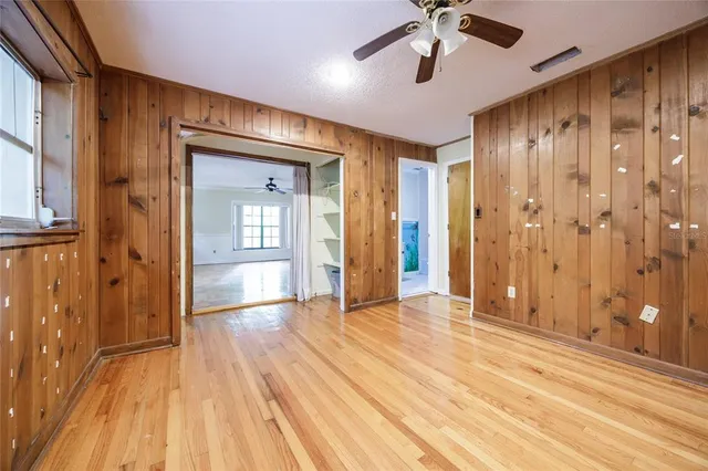 wooden floor in an empty room with a window