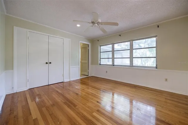 a view of empty room with wooden floor