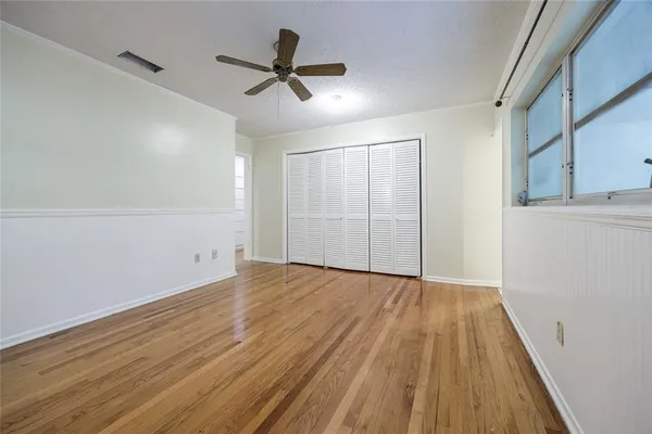 a view of a room with window wooden floor and windows