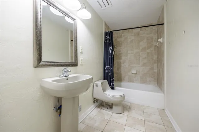 an aerial view of residential house with outdoor space and trees all around