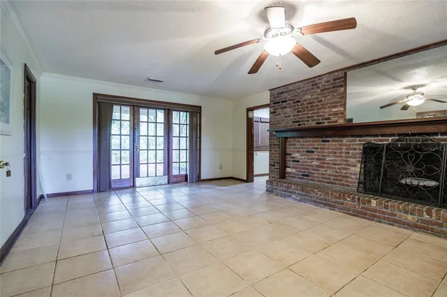 a view of an empty room with a fireplace and a large window
