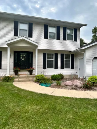 a kitchen with stainless steel appliances kitchen island granite countertop a refrigerator and a stove top oven