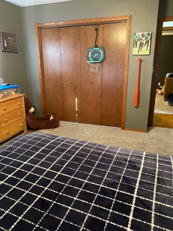 a bedroom with a bed and a table with mirror