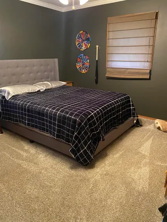 a bedroom with a bed and window