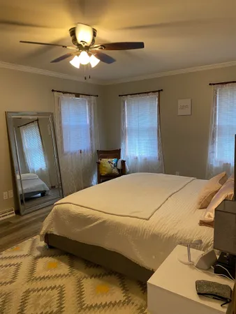 a bedroom with a bed and a chandelier