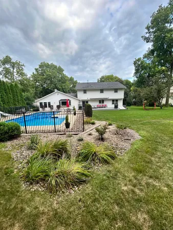a view of a garden with a house in the background