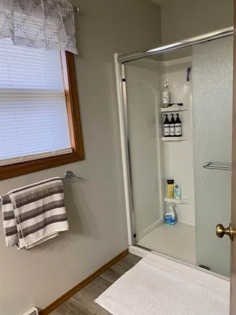 a bathroom with a shower and a mirror
