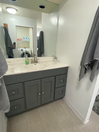 a bathroom with a double vanity sink and mirror