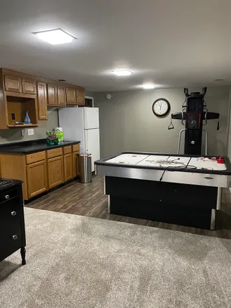 a living room with stainless steel appliances kitchen island granite countertop furniture and a view of kitchen