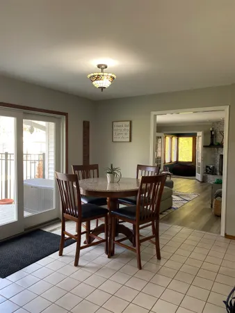 a view of a dining room with furniture and chandelier
