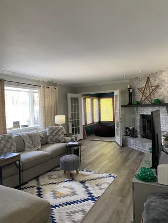 a living room with furniture window and a fireplace
