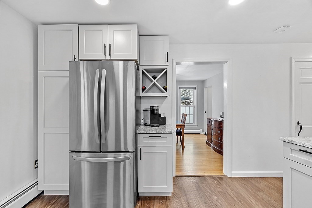 75 Stark Road Derry, NH 03038 - Photo 6 of 39 a kitchen with stainless steel appliances a refrigerator and wooden floor