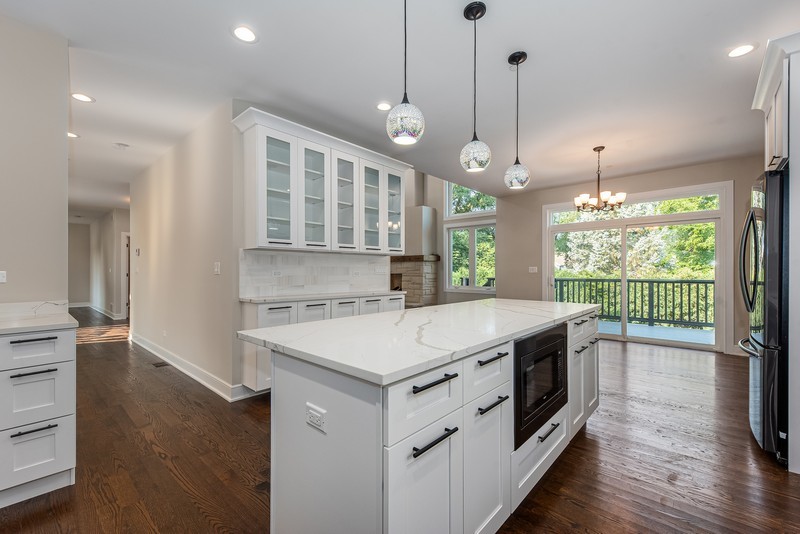 5700 Wolf Road Western Springs, IL 60558 - Photo 11 of 39 a kitchen that has a stove a sink and a wooden floor