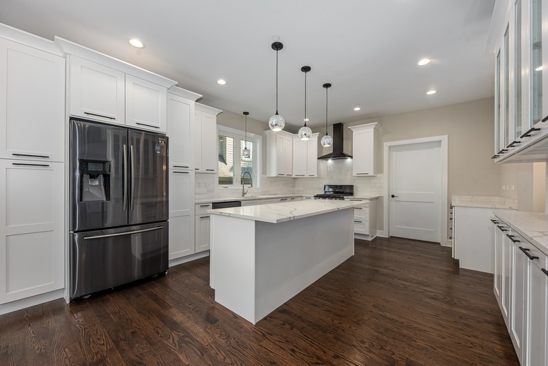 5700 Wolf Road Western Springs, IL 60558 - Photo 12 of 39 a kitchen with kitchen island white cabinets and stainless steel appliances