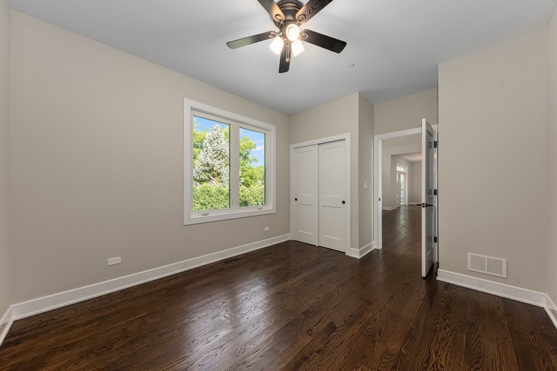 5700 Wolf Road Western Springs, IL 60558 - Photo 16 of 39 an empty room with wooden floor and windows