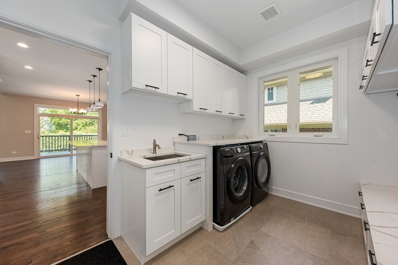 5700 Wolf Road Western Springs, IL 60558 - Photo 18 of 39 a utility room with cabinets dryer and washer