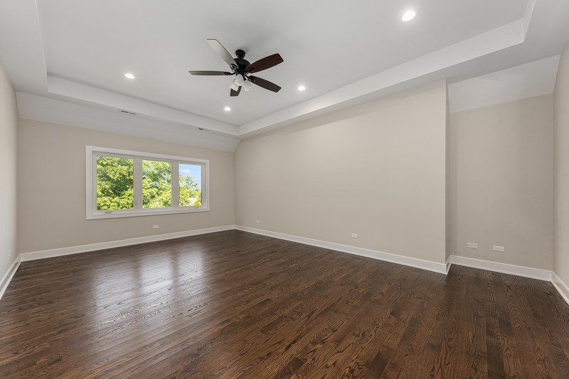 5700 Wolf Road Western Springs, IL 60558 - Photo 20 of 39 a view of an empty room with wooden floor and a window