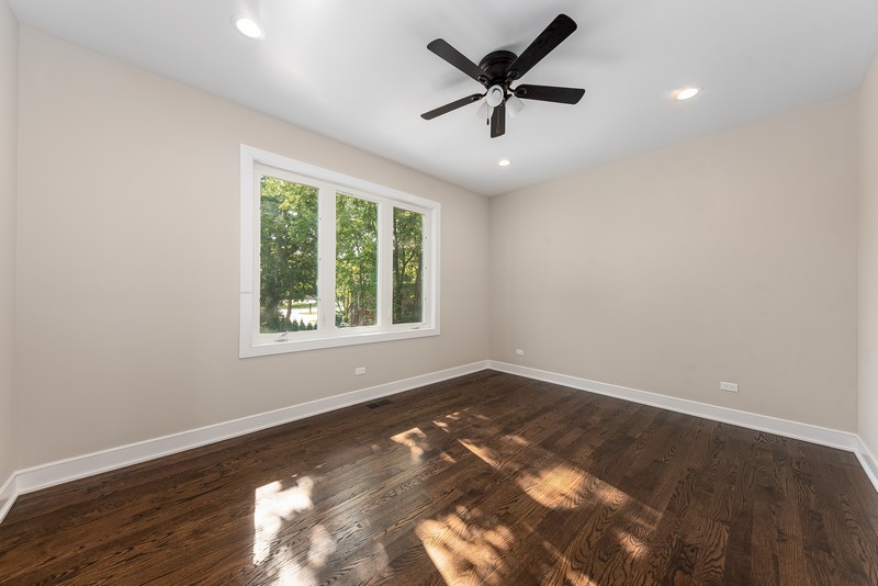 5700 Wolf Road Western Springs, IL 60558 - Photo 3 of 39 an empty room with wooden floor and windows