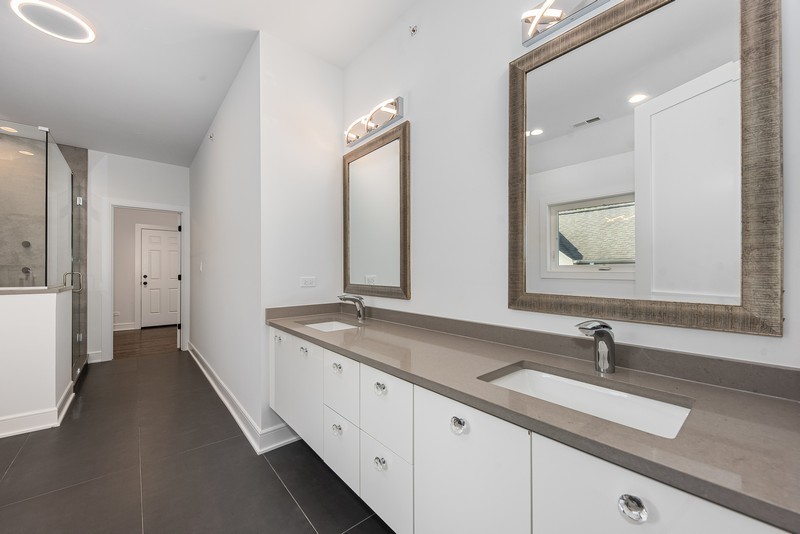 5700 Wolf Road Western Springs, IL 60558 - Photo 22 of 39 a bathroom with a double vanity sink and a mirror