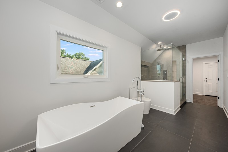 5700 Wolf Road Western Springs, IL 60558 - Photo 23 of 39 a bathroom with a bathtub and a shower