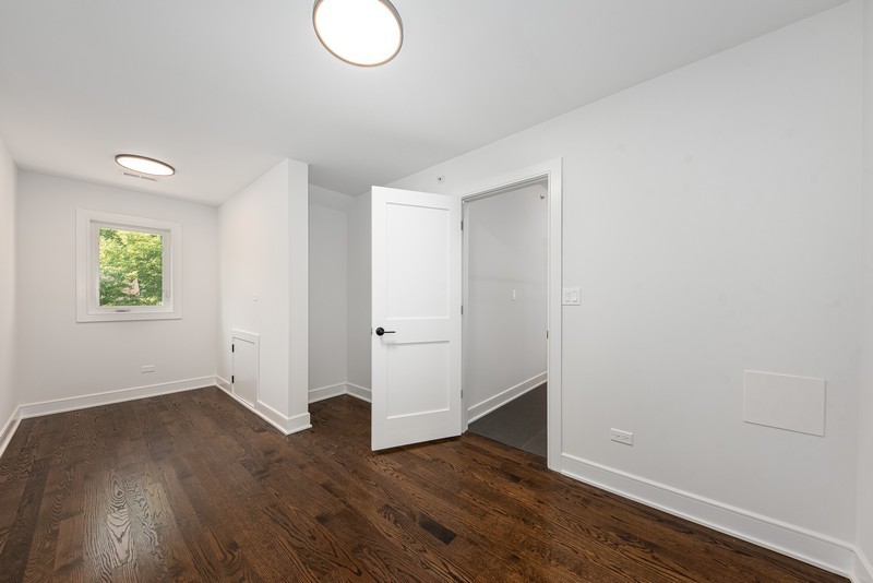5700 Wolf Road Western Springs, IL 60558 - Photo 24 of 39 an empty room with wooden floor and windows