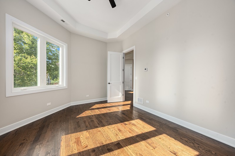 5700 Wolf Road Western Springs, IL 60558 - Photo 26 of 39 a view of an empty room with wooden floor and a window