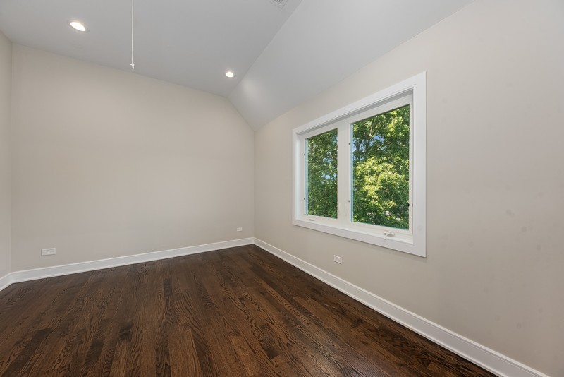5700 Wolf Road Western Springs, IL 60558 - Photo 30 of 39 an empty room with wooden floor and windows