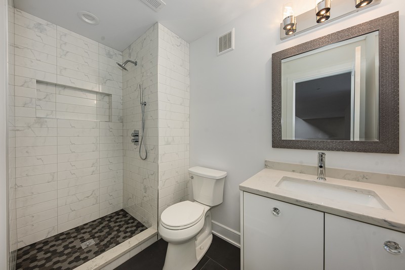 5700 Wolf Road Western Springs, IL 60558 - Photo 37 of 39 a bathroom with a sink toilet a shower and a mirror
