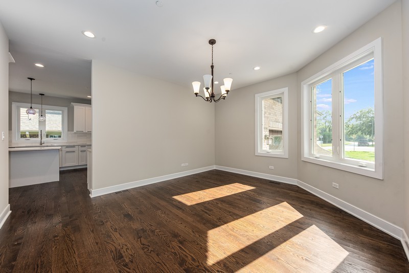 5700 Wolf Road Western Springs, IL 60558 - Photo 6 of 39 a view of an empty room with window and wooden floor