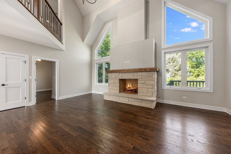 5700 Wolf Road Western Springs, IL 60558 - Photo 8 of 39 a view of an empty room with wooden floor and a window