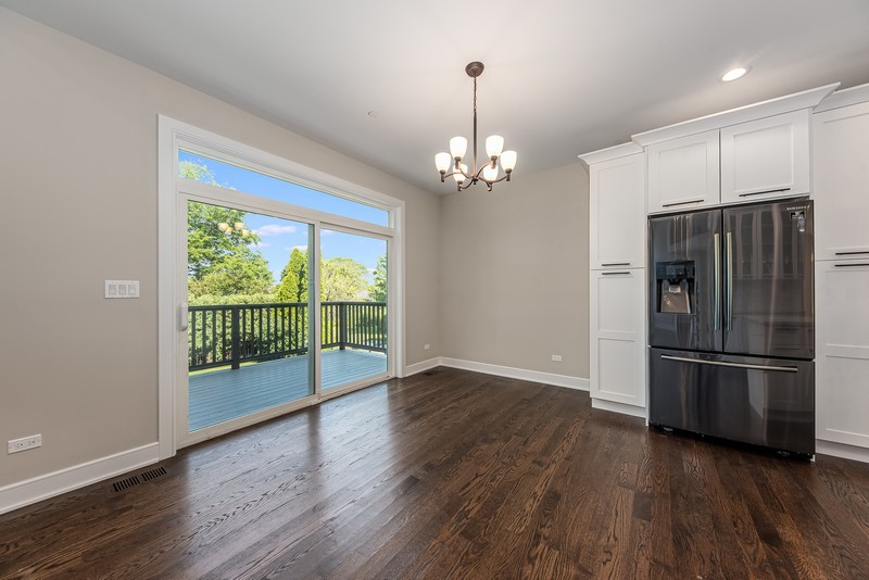 5700 Wolf Road Western Springs, IL 60558 - Photo 10 of 39 a view of a refrigerator in kitchen and wooden floor