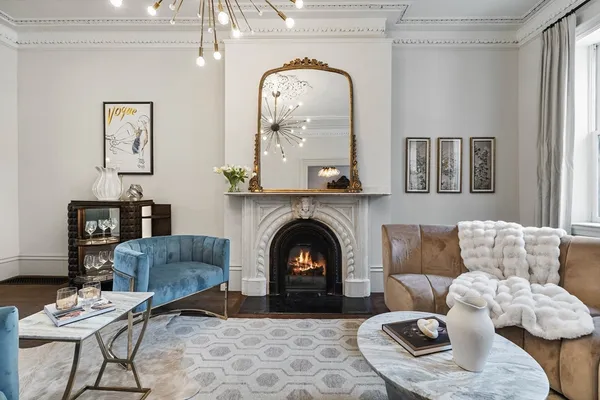 a living room with furniture and a fireplace