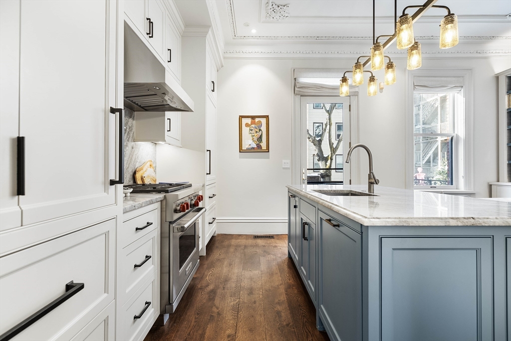 93 Third Street, Unit 93 Cambridge, MA 02141 - Photo 12 of 42 a kitchen with stainless steel appliances granite countertop a sink and stove
