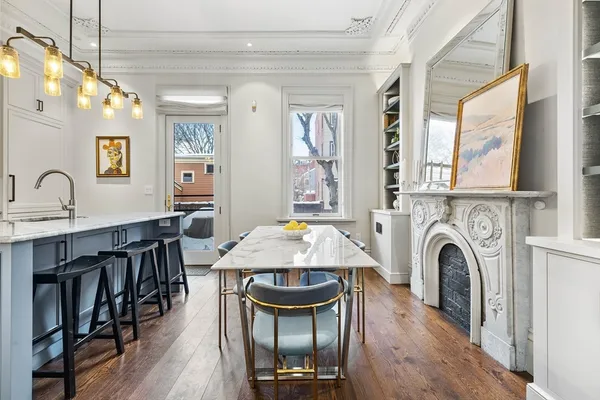a living room with furniture a fireplace and a chandelier