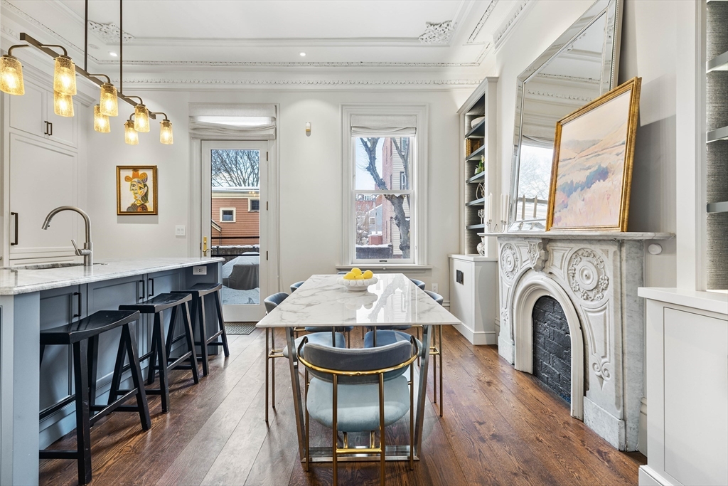 93 Third Street, Unit 93 Cambridge, MA 02141 - Photo 14 of 42 a living room with furniture a fireplace and a chandelier