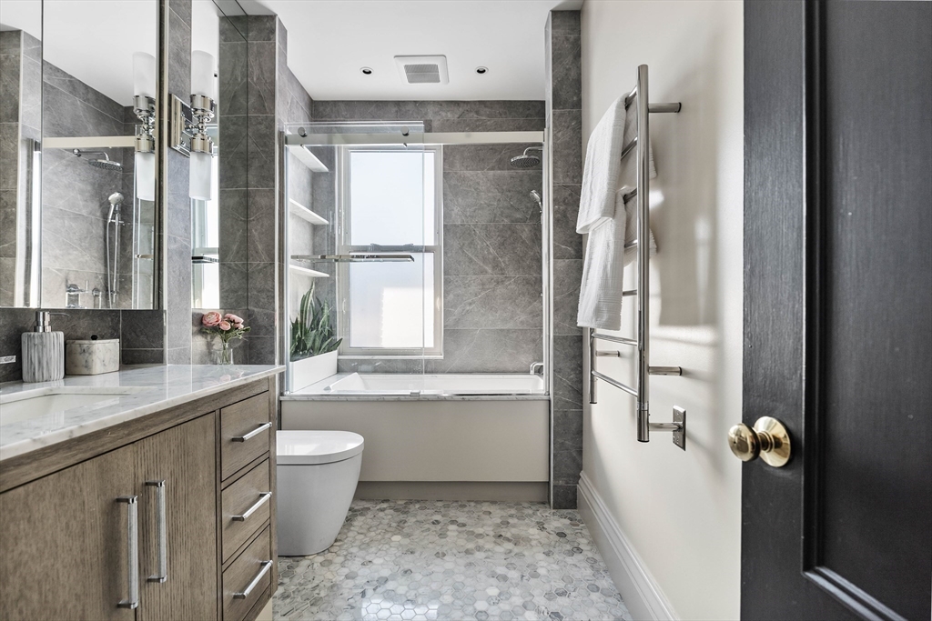 93 Third Street, Unit 93 Cambridge, MA 02141 - Photo 25 of 42 a bathroom with a granite countertop sink toilet and shower