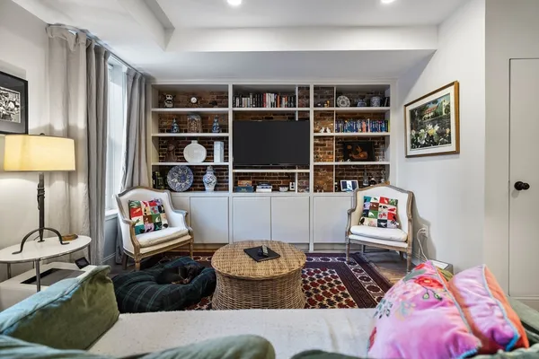 a living room with furniture and book shelf