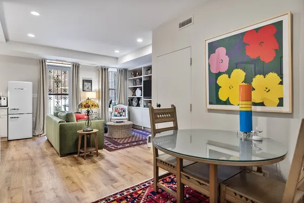a living room with furniture and wall paintings