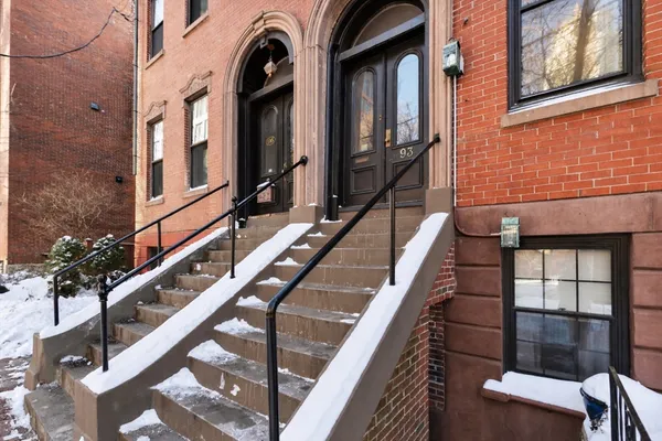 a view of building with glass windows and furniture