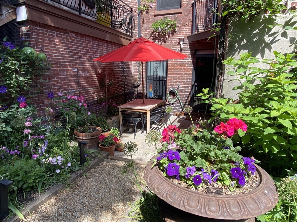 93 Third Street, Unit 93 Cambridge, MA 02141 - Photo 40 of 42 a view of a house with a yard and garden