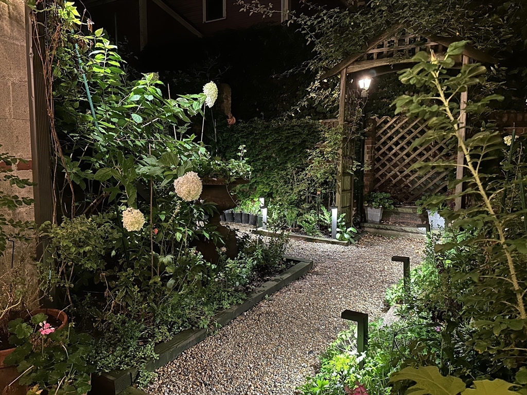 93 Third Street, Unit 93 Cambridge, MA 02141 - Photo 41 of 42 a backyard of a house with lots of green space and a fountain