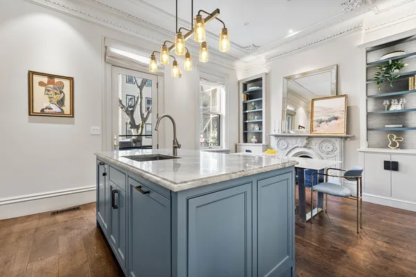 a kitchen with center island table and chairs in it