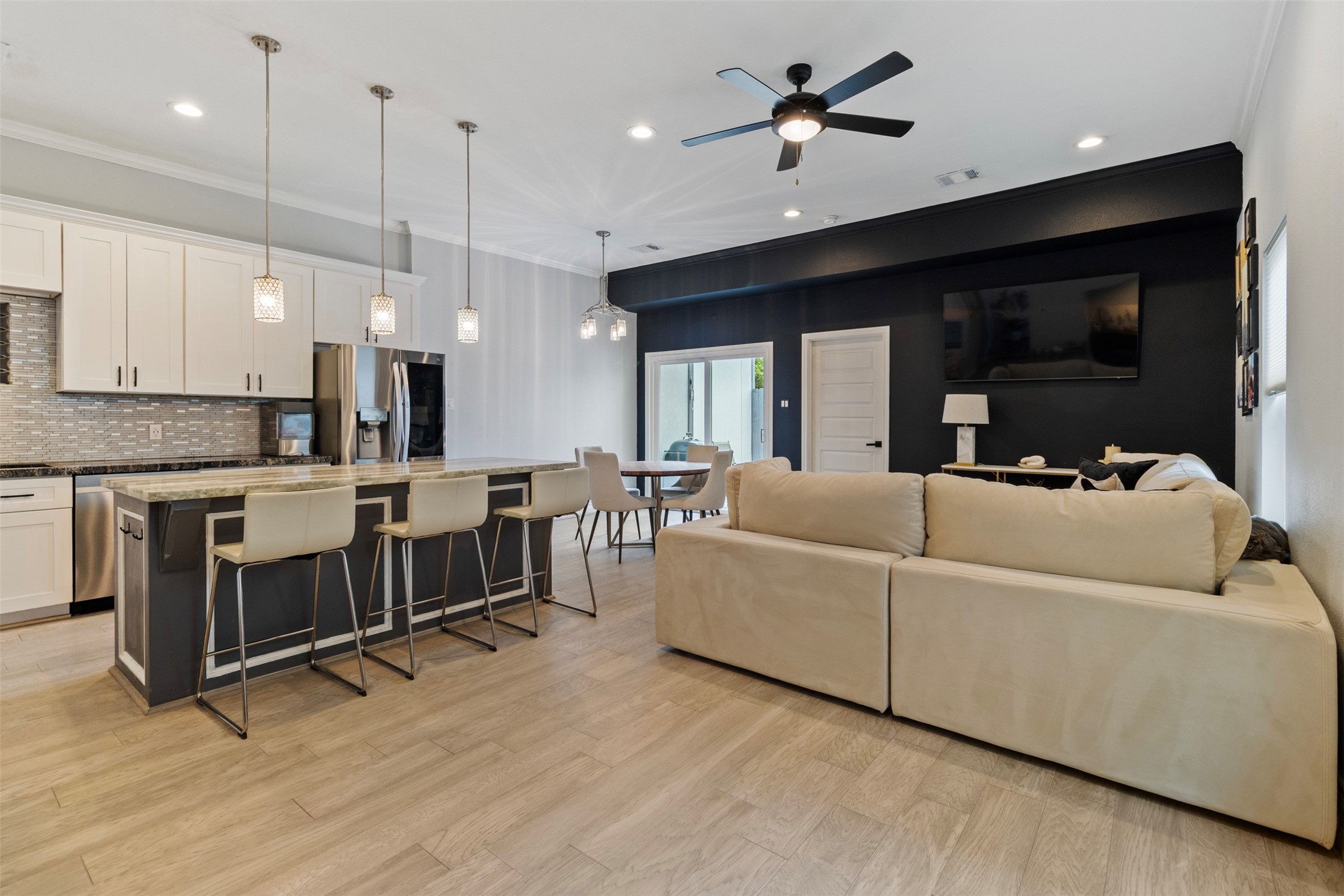 6706 Lozier Street Houston, TX 77021 - Photo 20 of 32 a living room with furniture ceiling fan and a wooden floor