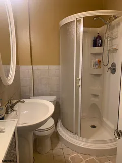 a bathroom with a shower and mirror