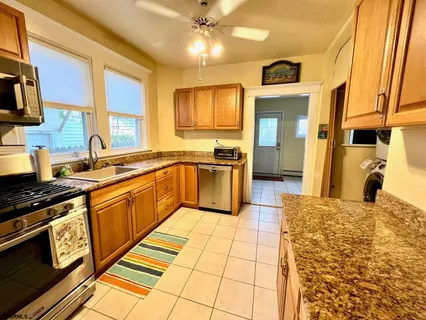 a kitchen with stainless steel appliances granite countertop a sink and cabinets